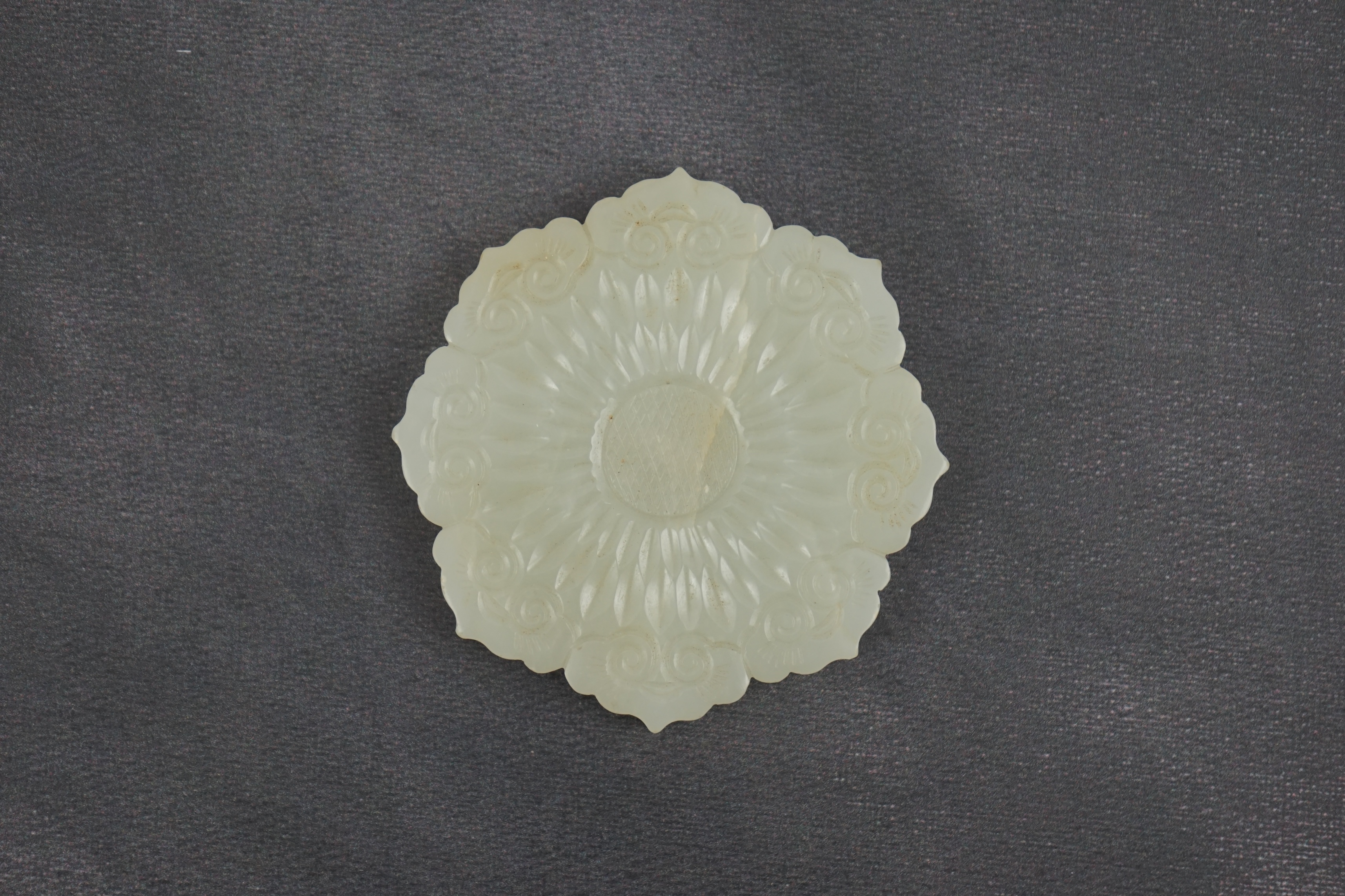 A Chinese pale celadon jade ‘mallow flower’ plaque, 18th/19th century